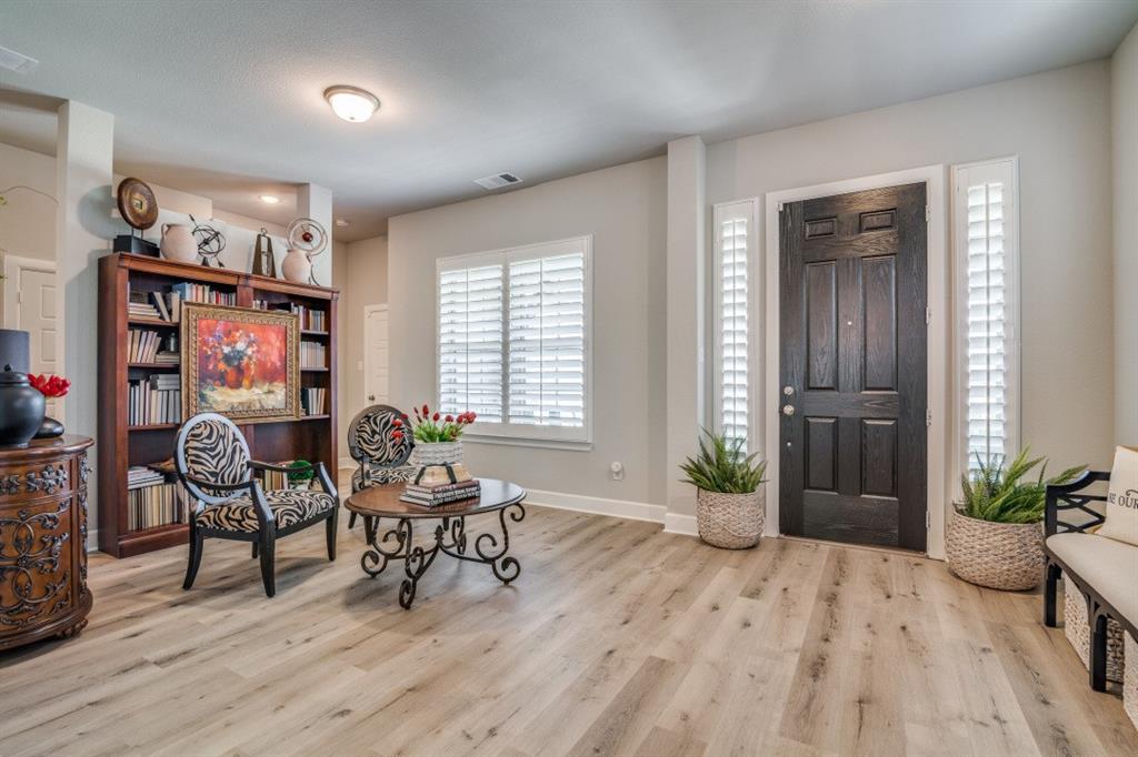 1268 Caprock Drive Forney, TX 75126 - Photo 6 of 35 a living room with furniture and wooden floor