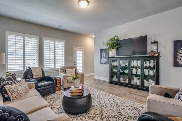 a living room with furniture and a potted plant