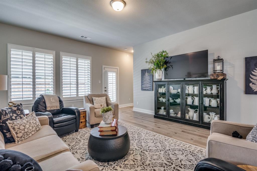 1268 Caprock Drive Forney, TX 75126 - Photo 9 of 35 a living room with furniture and a potted plant