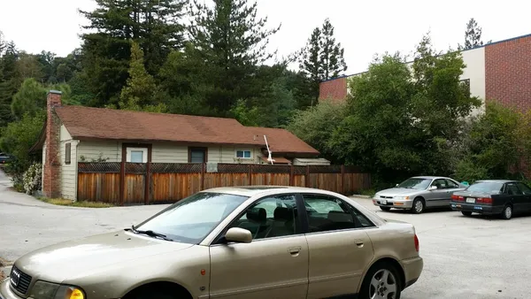 a view of multiple houses with a car parked