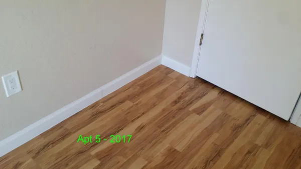 a view of a room with wooden floor