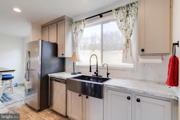 a kitchen with a sink stove top oven and refrigerator