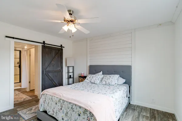 a bedroom with a large bed and a chandelier