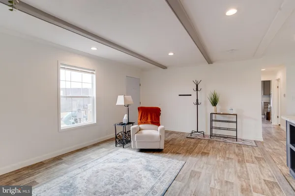 a living room with furniture and kitchen view