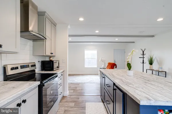 a room with furniture and a kitchen view