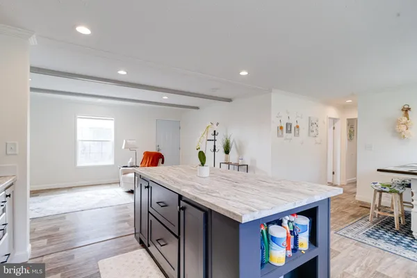 a kitchen with stainless steel appliances granite countertop a sink and a refrigerator