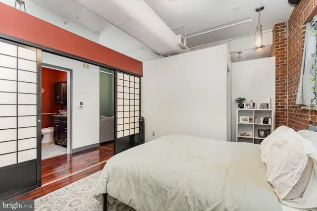 a bedroom with a large bed and a chandelier