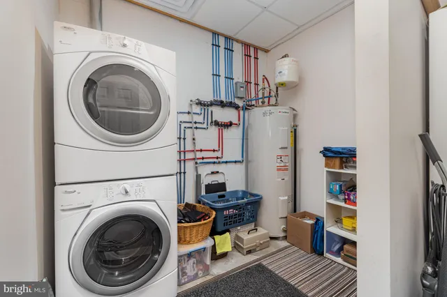 a living room with furniture and a shelf