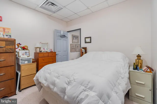 a bedroom with a bed and a dresser