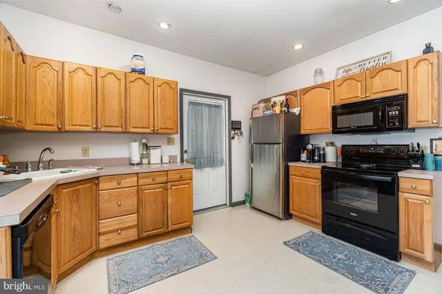 a kitchen with stainless steel appliances granite countertop a refrigerator stove and sink