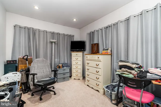 a view of a workspace with furniture and a closet