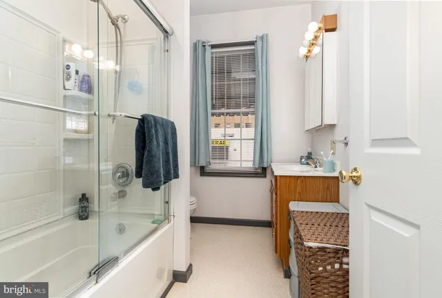 a bathroom with a tub sink and mirror