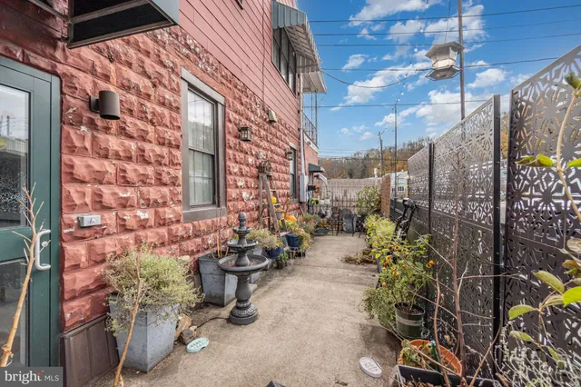 a view of a patio with plants and table and chairs