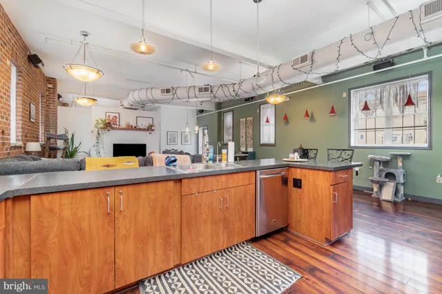a large kitchen with stainless steel appliances granite countertop a sink and cabinets