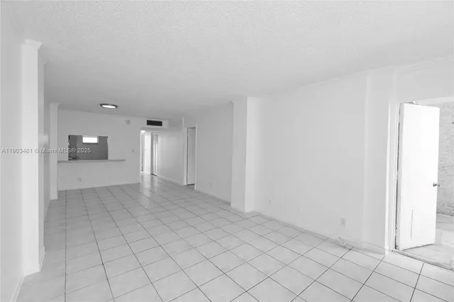 a view of an empty room with glass door