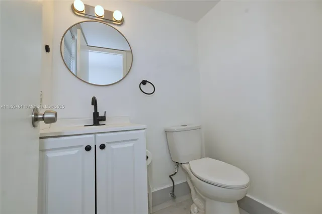 a bathroom with a toilet a sink and a mirror