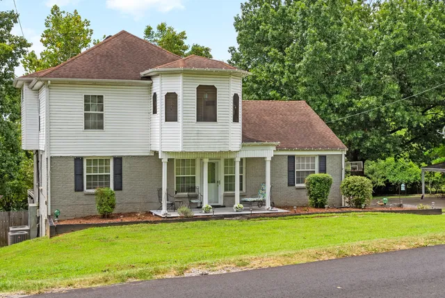 a front view of house with yard and green space