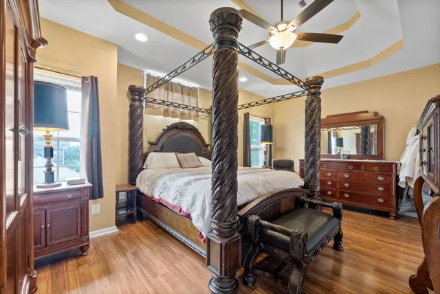 a bedroom with a bed and wooden floor