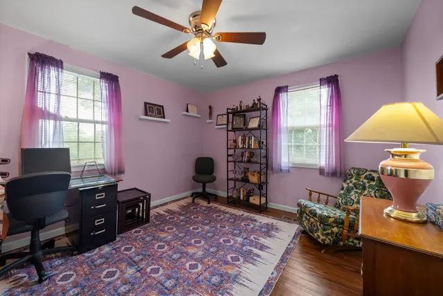 a view of a workspace with furniture and a window