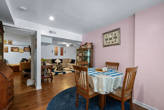 a dining room with furniture and wooden floor