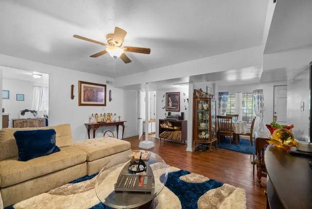 a living room with furniture and wooden floor