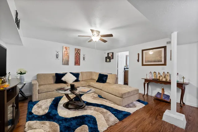 a living room with furniture and wooden floor