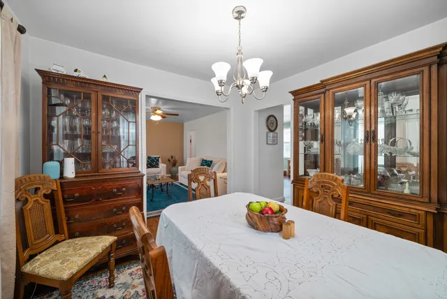 a view of a dining room with furniture large windows and wooden floor