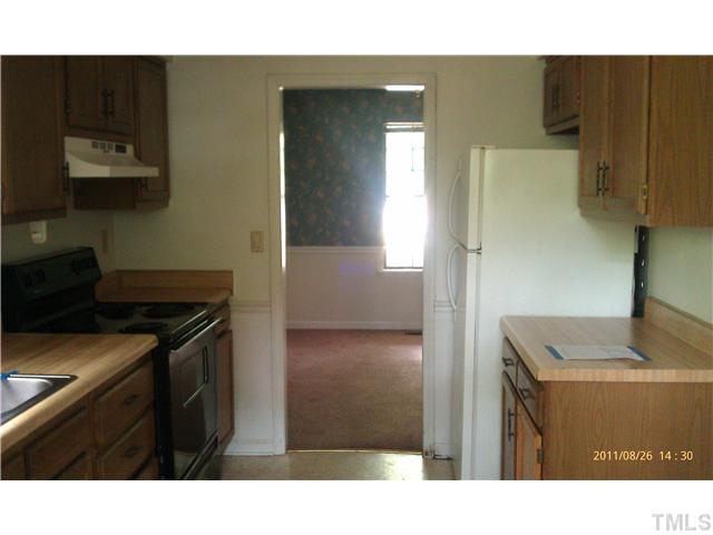 820 Horton Road Durham, NC 27704 - Photo 4 of 7 a kitchen with a stove and a refrigerator