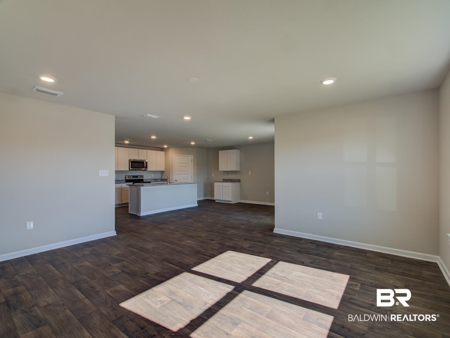 23953 Citation Loop Daphne, AL 36526 - Photo 8 of 49 Unfurnished living room featuring dark wood finished floors and recessed lighting