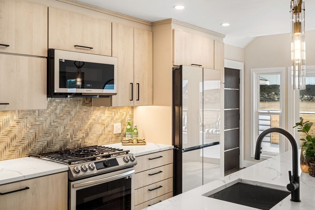84 School Street Melrose, MA 02176 - Photo 11 of 34 a kitchen with stainless steel appliances a refrigerator stove and microwave