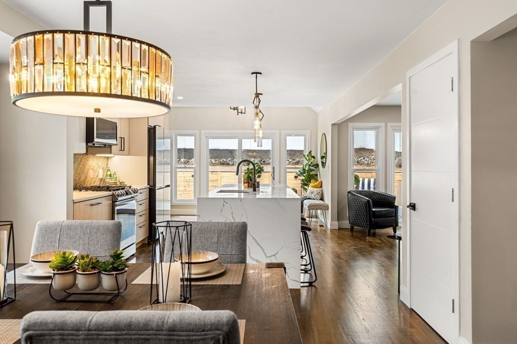 84 School Street Melrose, MA 02176 - Photo 14 of 34 a living room with furniture and a chandelier