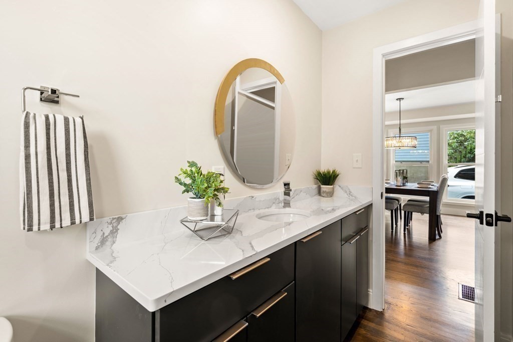 84 School Street Melrose, MA 02176 - Photo 19 of 34 a bathroom with a sink a mirror and a potted plant