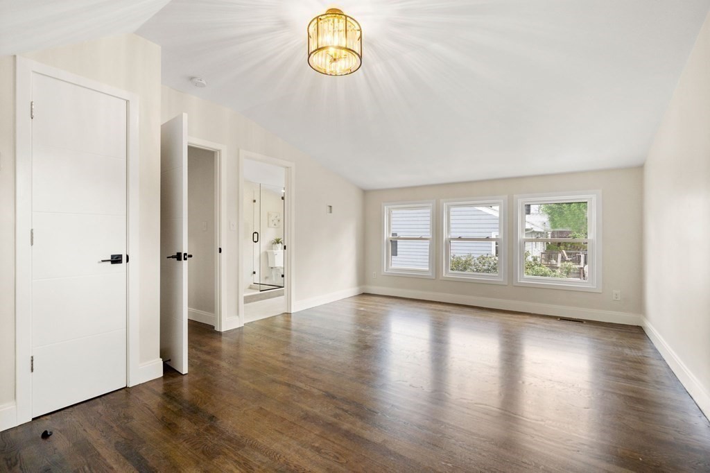 84 School Street Melrose, MA 02176 - Photo 21 of 34 an empty room with wooden floor and window