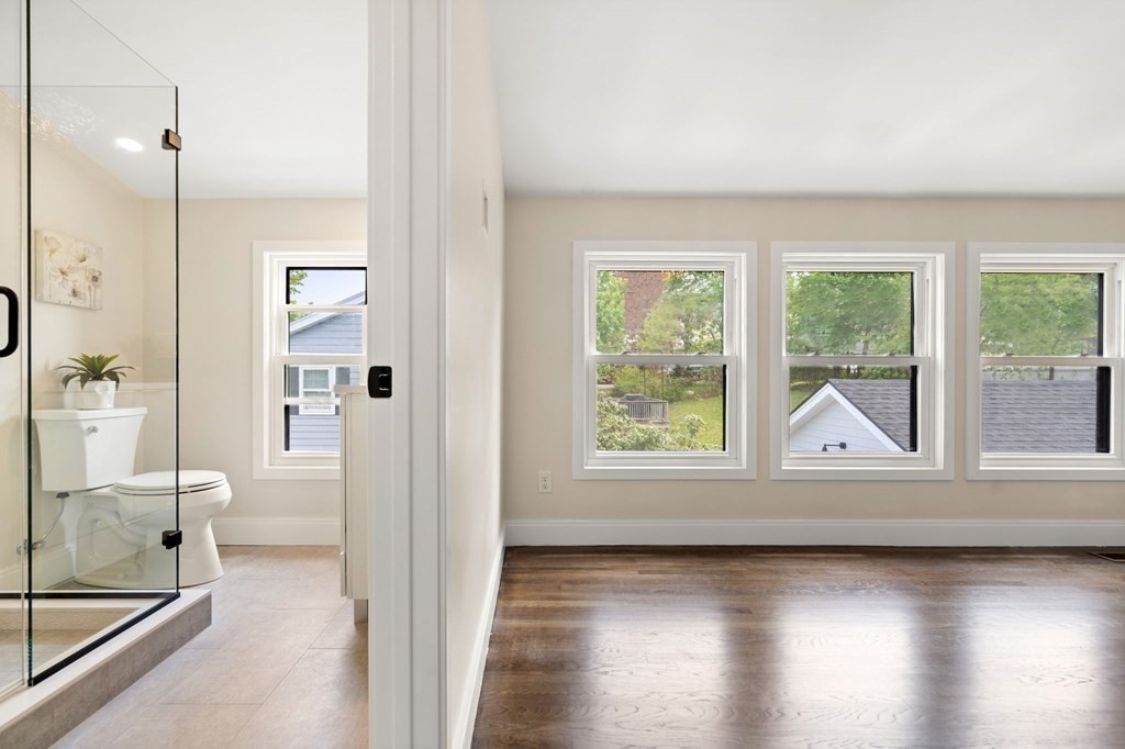 84 School Street Melrose, MA 02176 - Photo 29 of 34 a view of a bathroom with a glass door and a window
