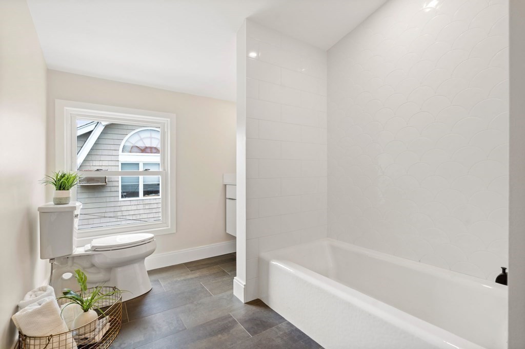 84 School Street Melrose, MA 02176 - Photo 31 of 34 a bathroom with a toilet a sink and bathtub