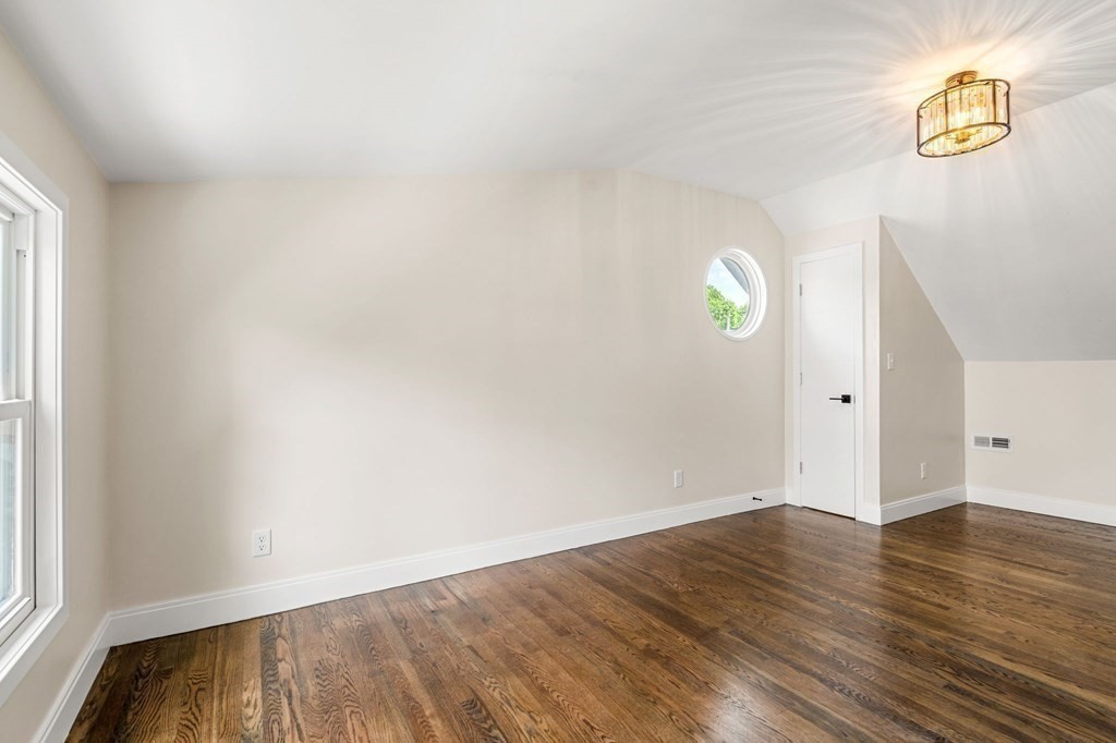 84 School Street Melrose, MA 02176 - Photo 32 of 34 a view of empty room with wooden floor and fan