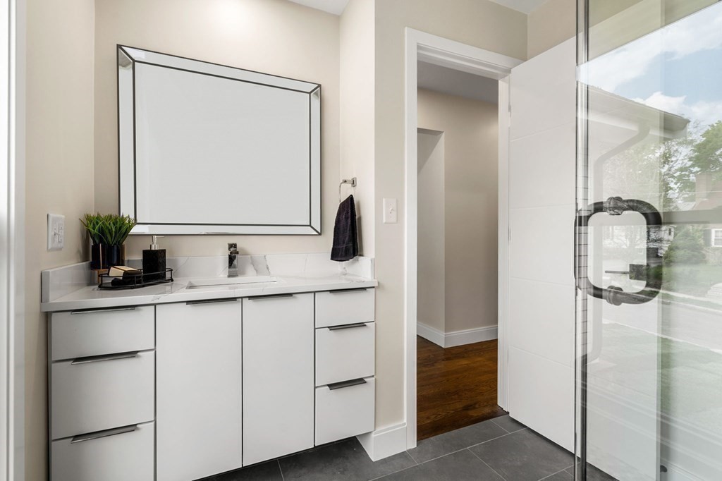 84 School Street Melrose, MA 02176 - Photo 33 of 34 a bathroom with a double vanity sink and mirror