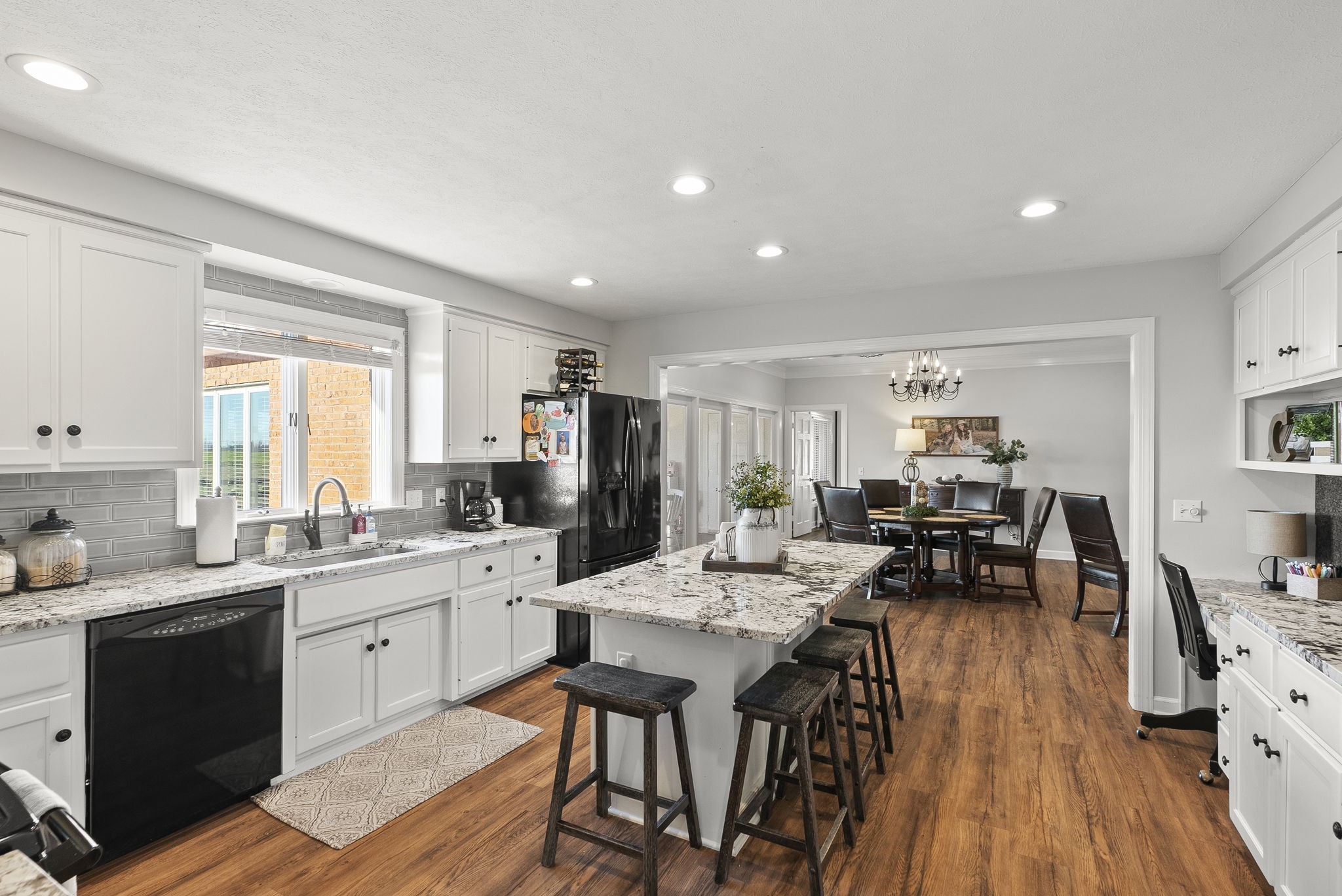 4767 Barren Plains Road Springfield, TN 37172 - Photo 29 of 68 a open dining room with stainless steel appliances kitchen island granite countertop a stove a sink a dining table and chairs