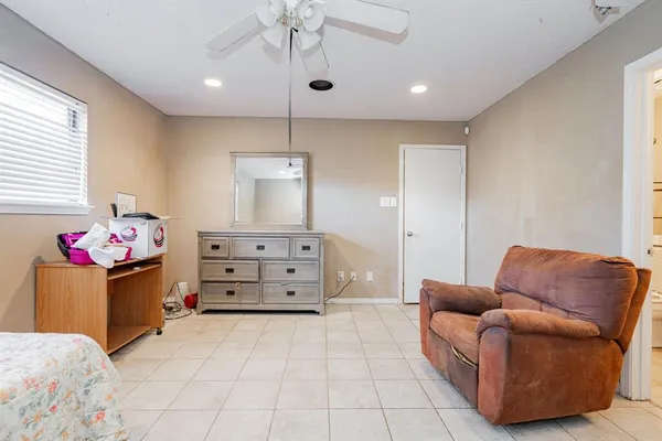 a living room with furniture and a baby crib