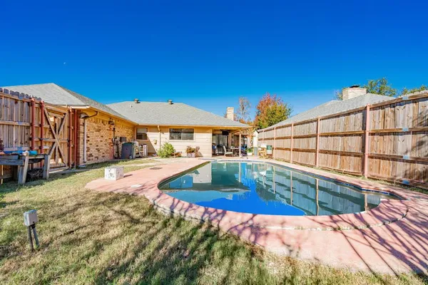 a view of a swimming pool with a patio