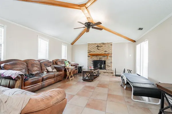 a living room with furniture a fireplace and a window