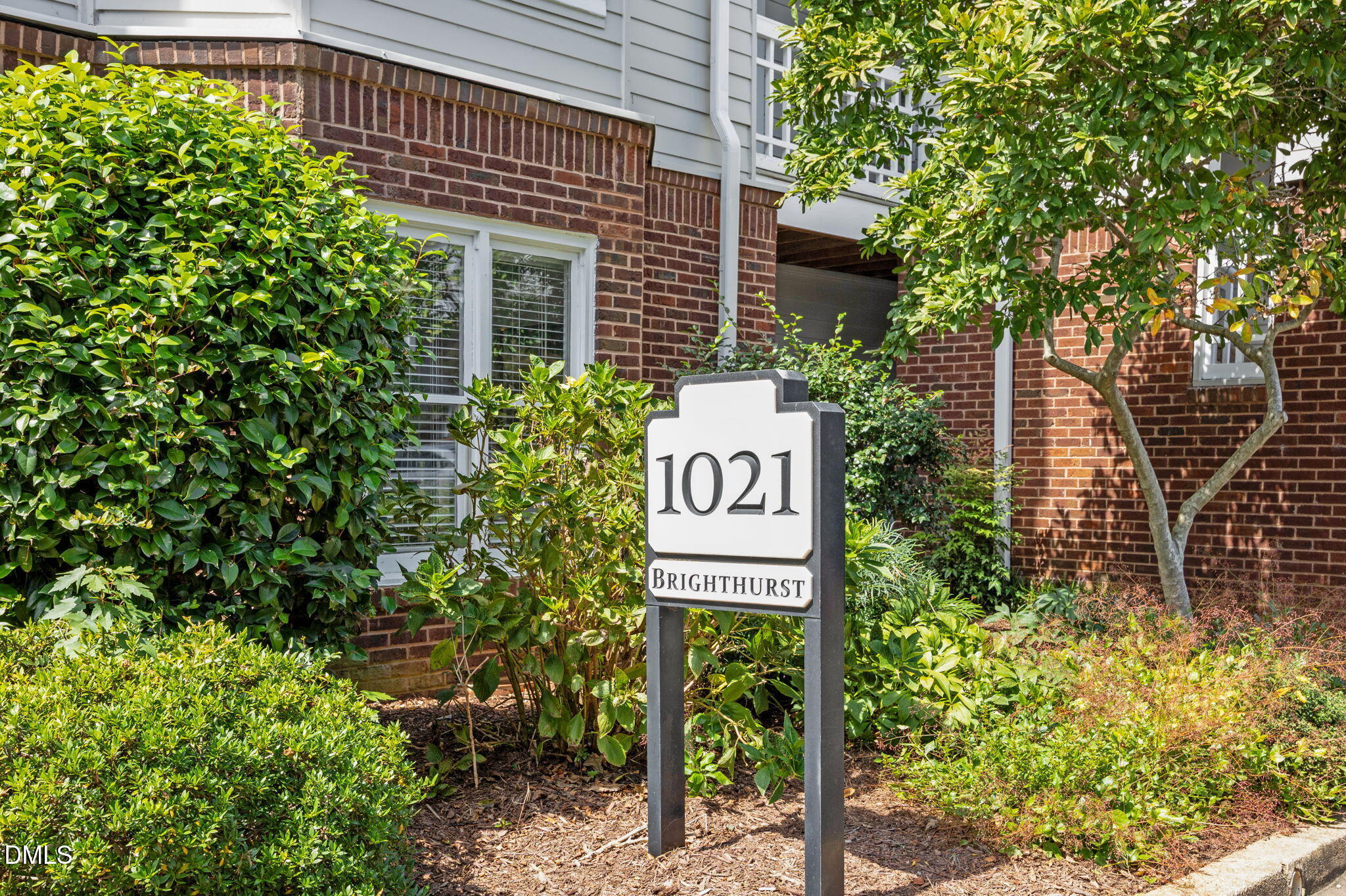 a sign that is on a brick wall