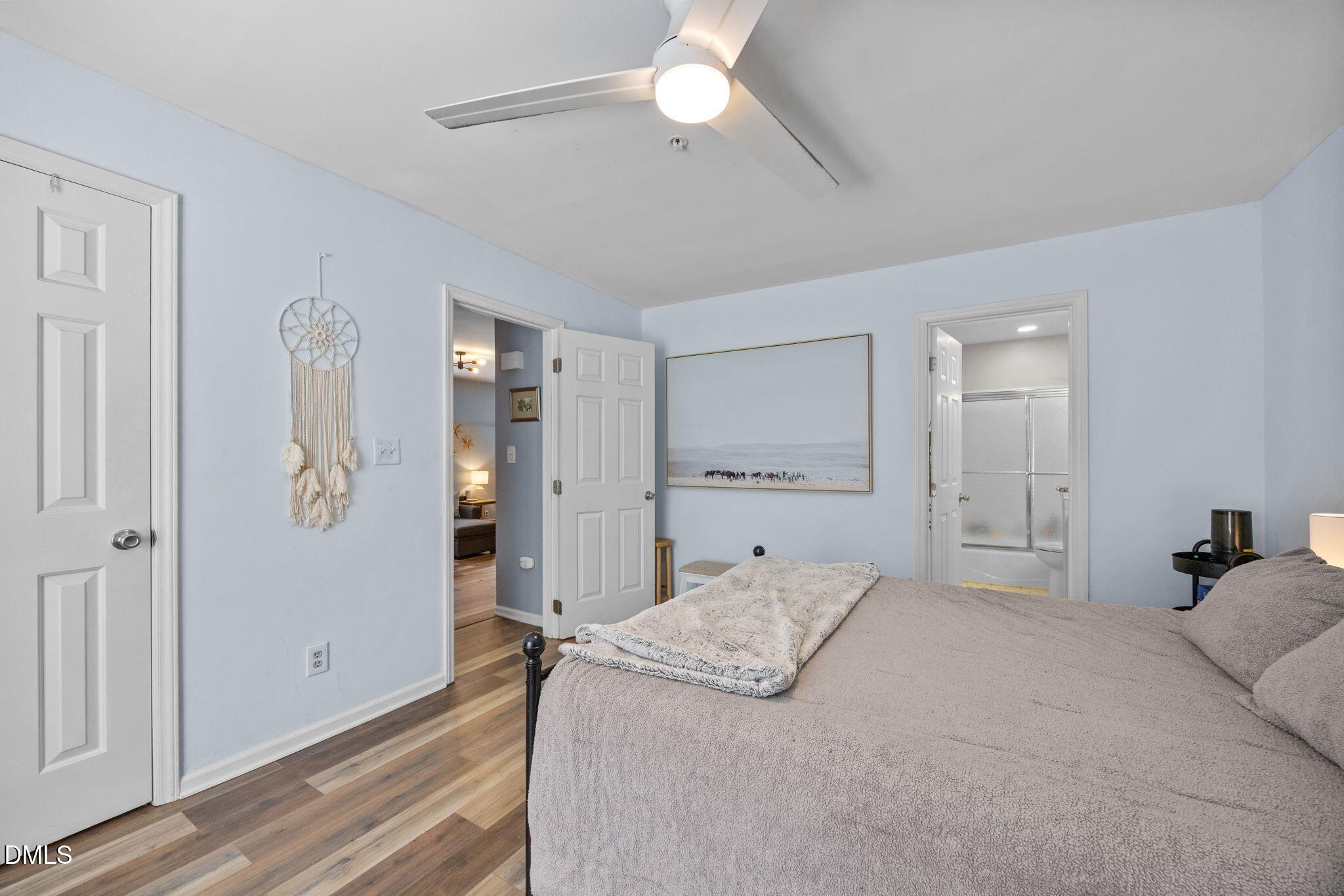 1021 Brighthurst Drive, Unit 103 Raleigh, NC 27605 - Photo 10 of 27 a bedroom with a bed and a chandelier
