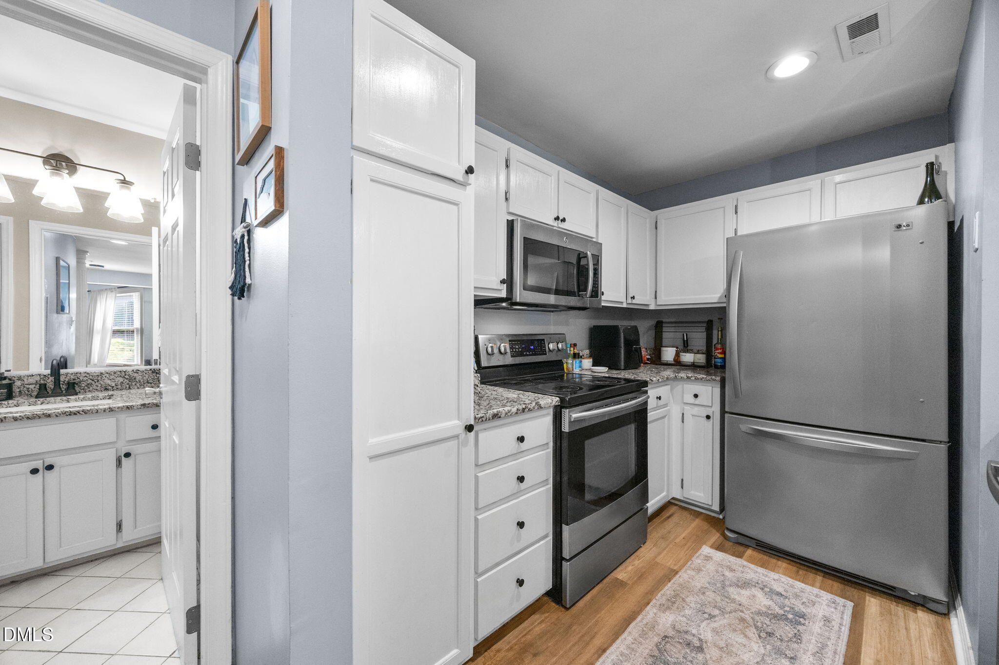 1021 Brighthurst Drive, Unit 103 Raleigh, NC 27605 - Photo 14 of 27 a kitchen with stainless steel appliances a refrigerator sink and microwave