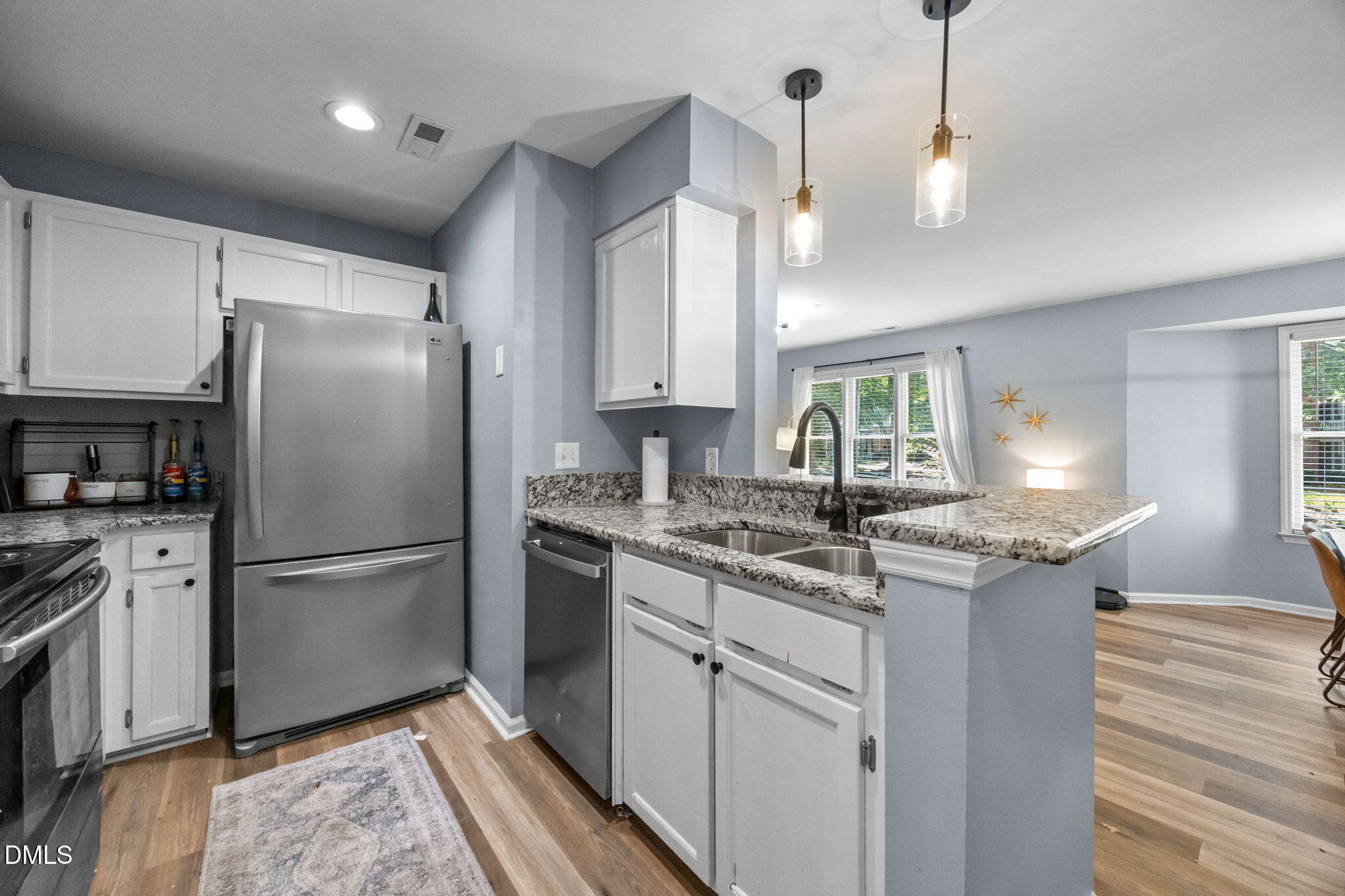 1021 Brighthurst Drive, Unit 103 Raleigh, NC 27605 - Photo 15 of 27 a kitchen with granite countertop a refrigerator and a sink