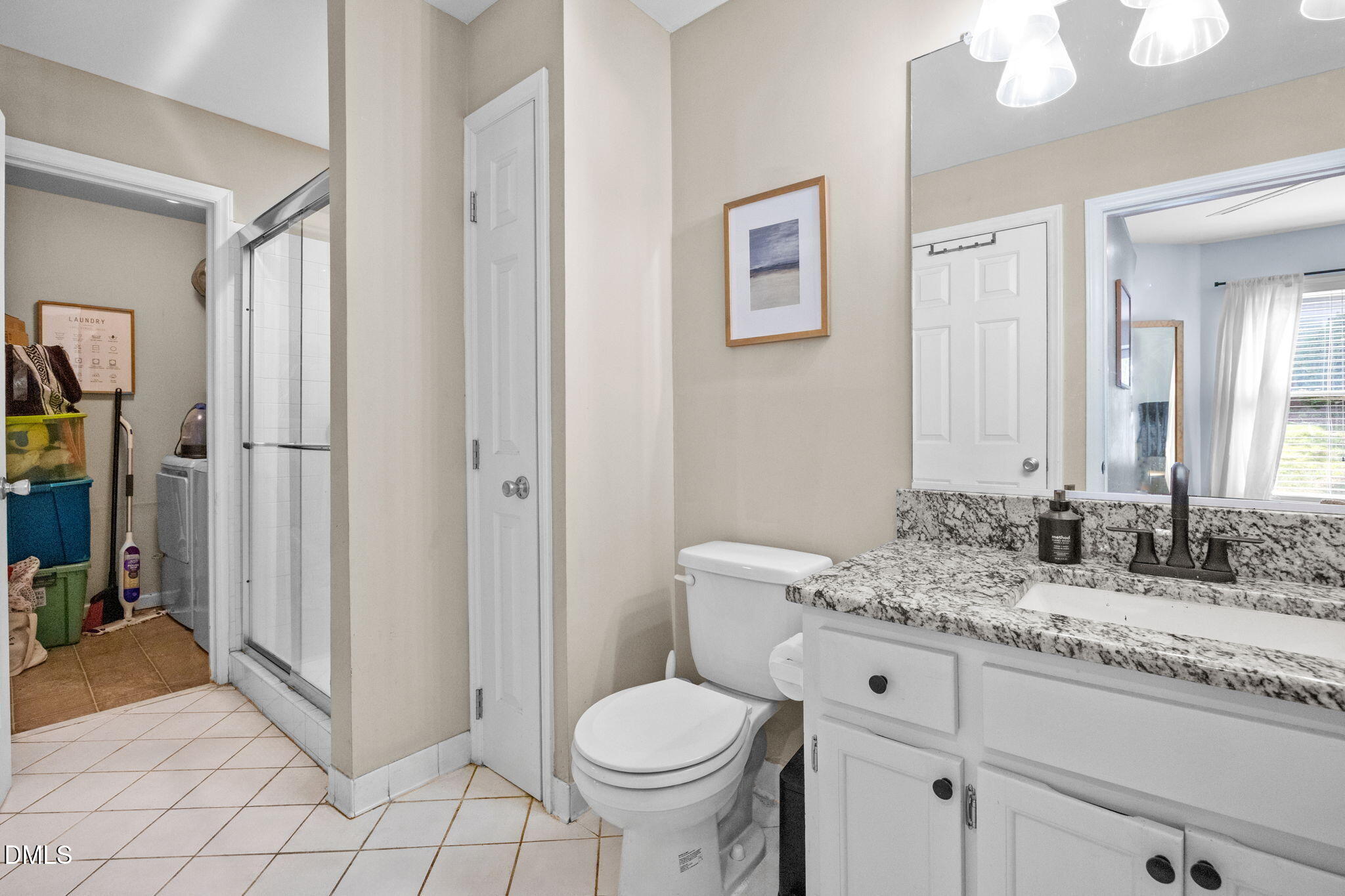 1021 Brighthurst Drive, Unit 103 Raleigh, NC 27605 - Photo 17 of 27 a bathroom with a granite countertop toilet sink and mirror