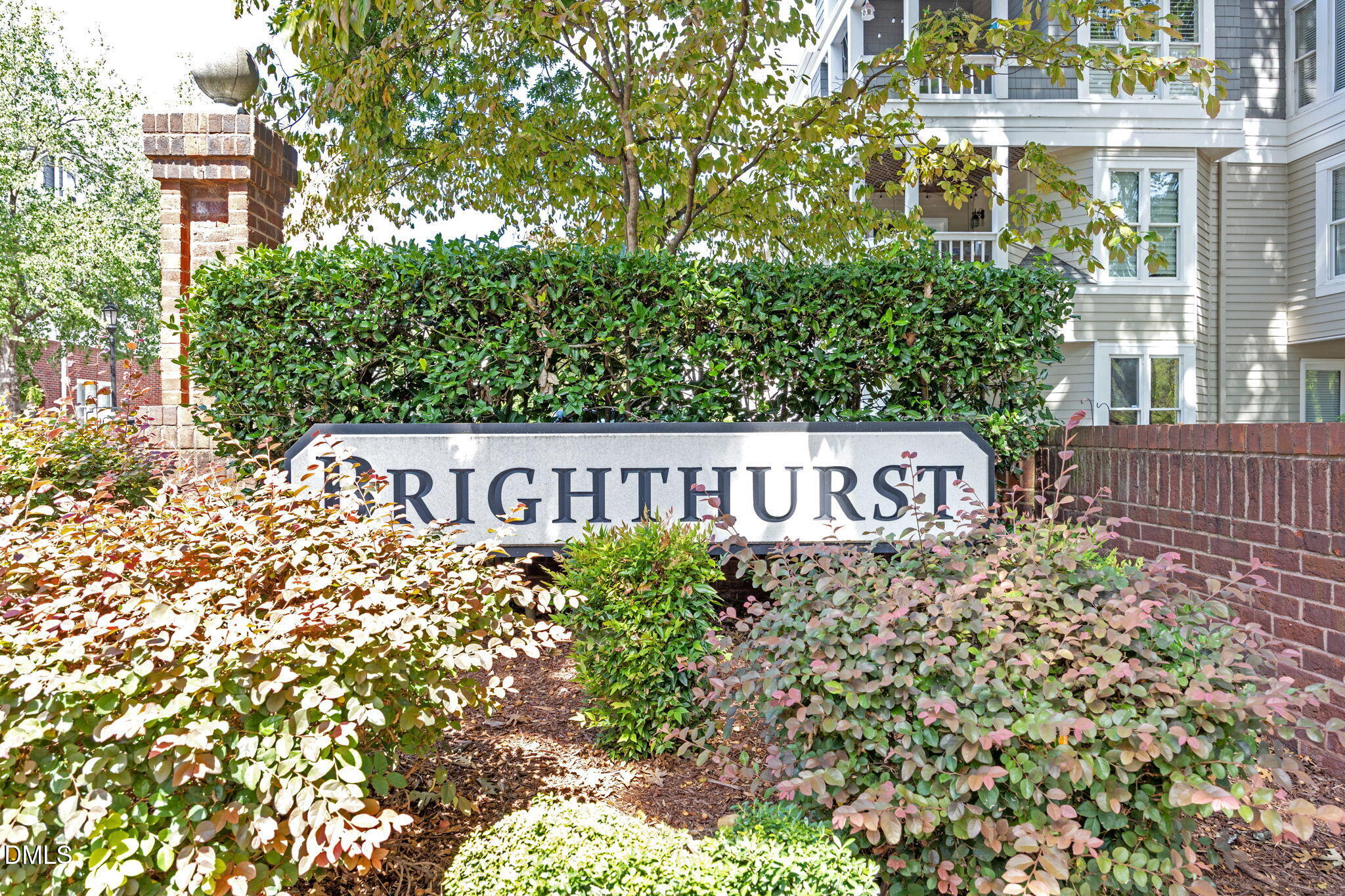 1021 Brighthurst Drive, Unit 103 Raleigh, NC 27605 - Photo 26 of 27 a sign broad in front of the red brick house