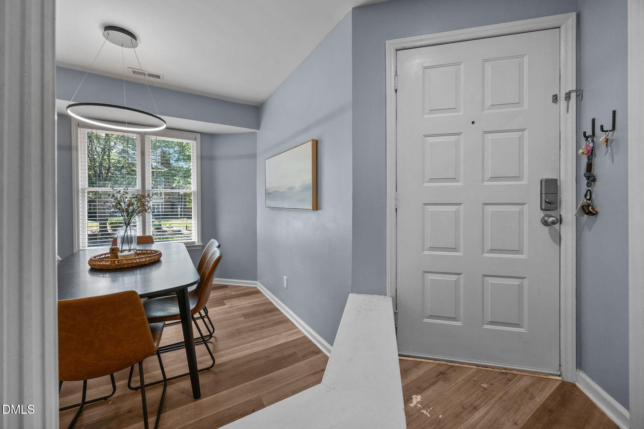 1021 Brighthurst Drive, Unit 103 Raleigh, NC 27605 - Photo 3 of 27 a view of a dining room with furniture and wooden floor