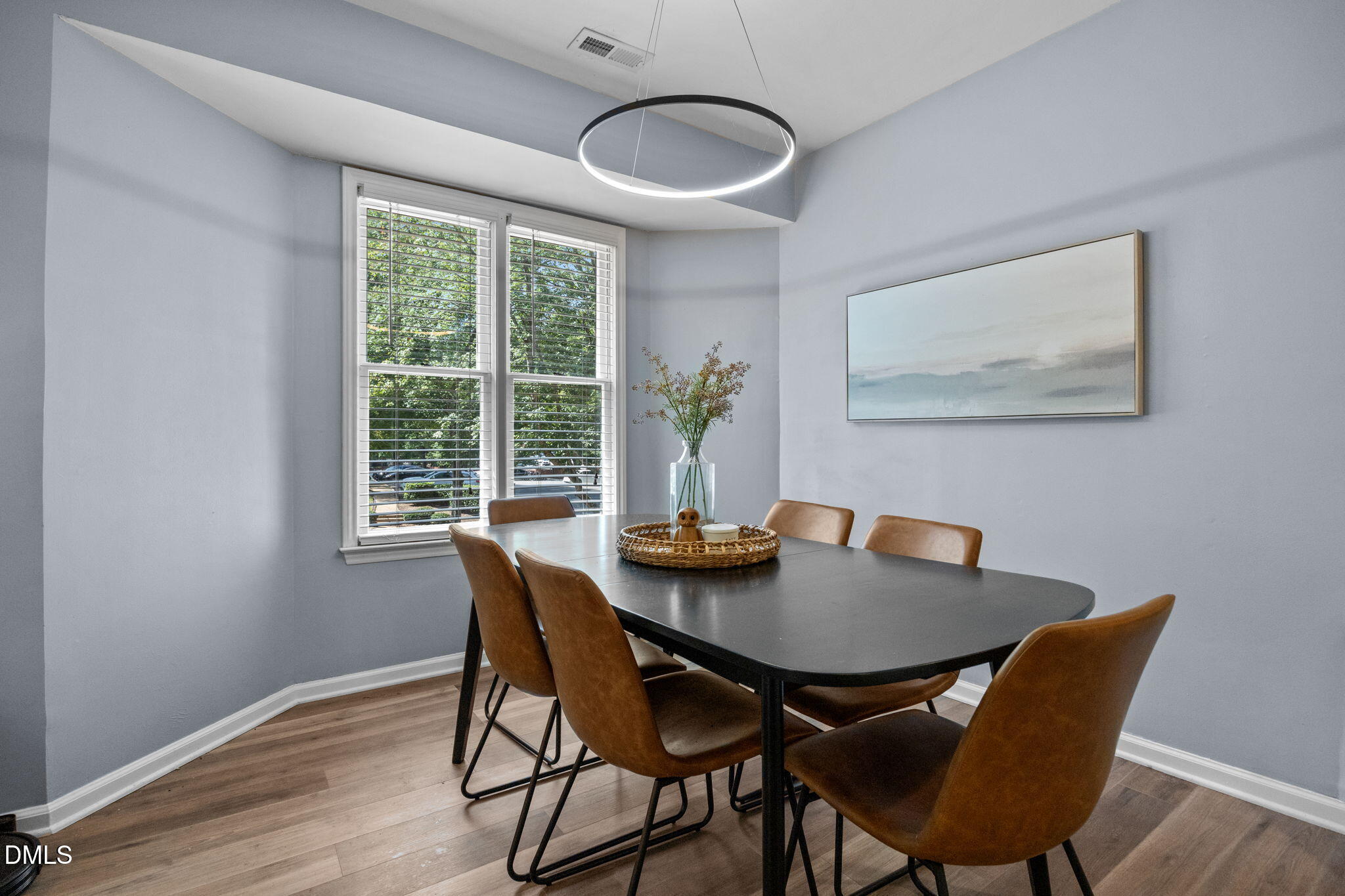 1021 Brighthurst Drive, Unit 103 Raleigh, NC 27605 - Photo 4 of 27 a view of a dining room with furniture and wooden floor