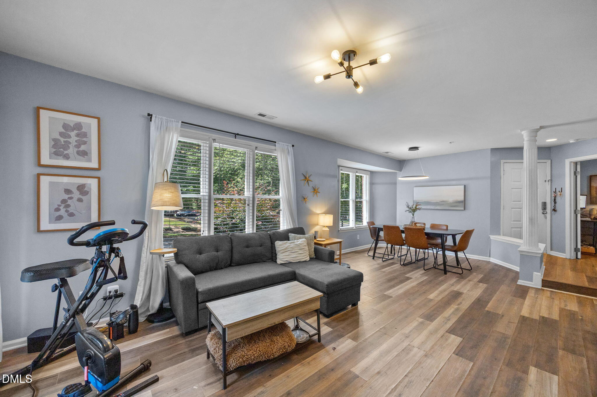 1021 Brighthurst Drive, Unit 103 Raleigh, NC 27605 - Photo 7 of 27 a living room with furniture and a wooden floor